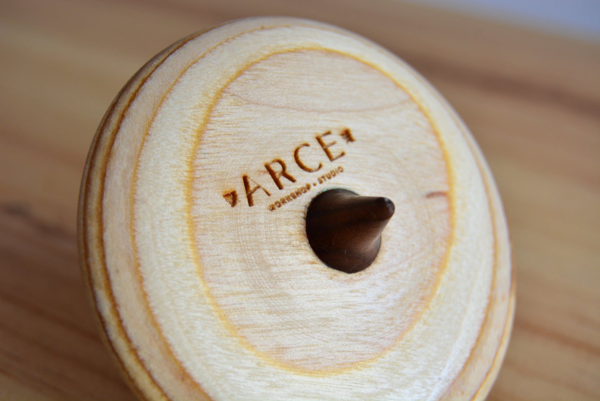 spintop made from natural wood and recycled skateboards