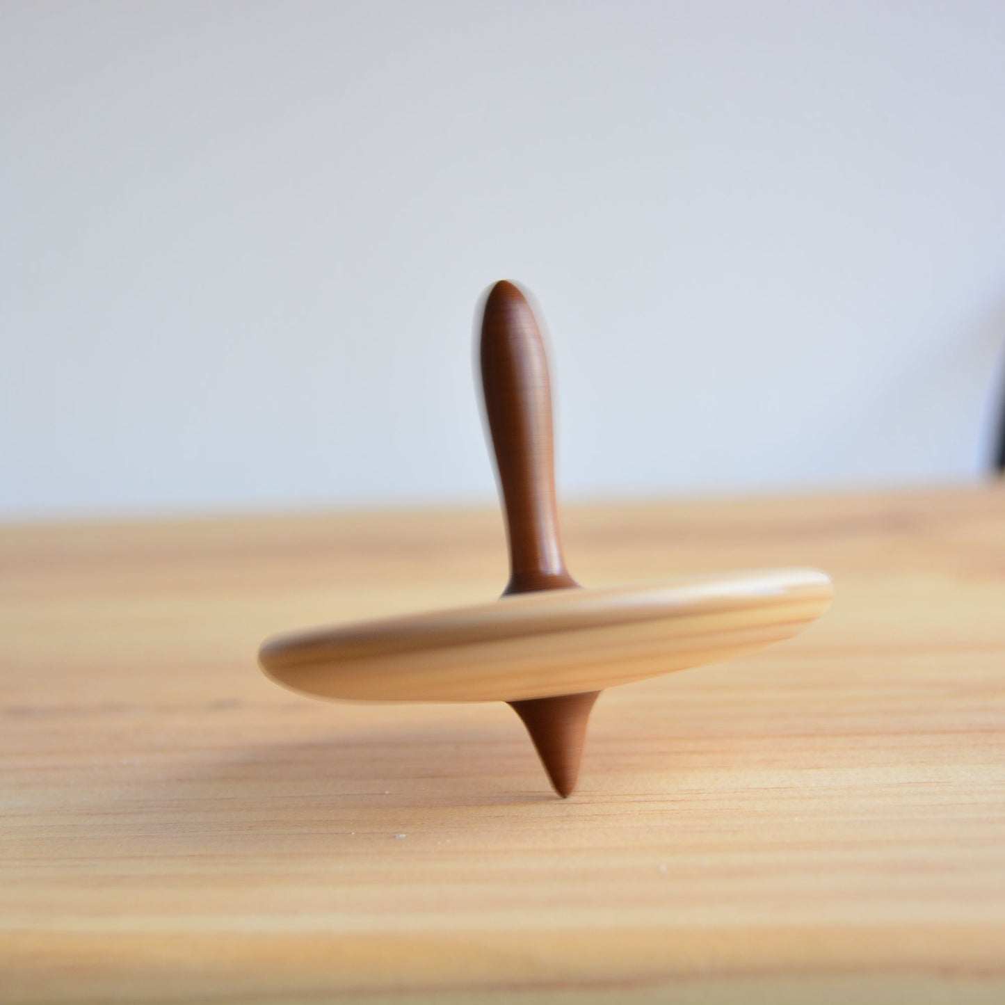 made from natural wood and a piece of a recycled skateboard